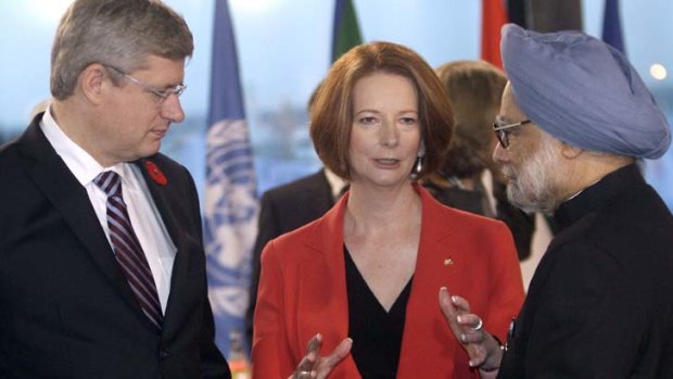 Summit in the bag ... Ms Gillard with the Canadian Prime Minister, Stephen Harper, and the Indian Prime Minister, Manmohan Singh.