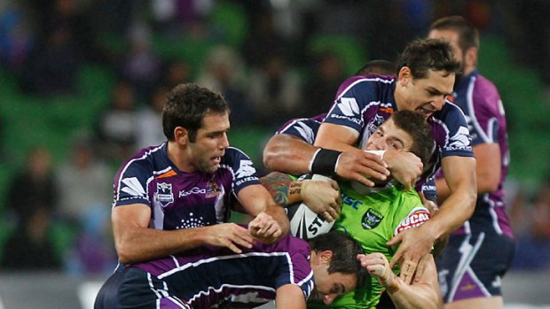 Early warning ... Melbourne and Queensland stars Cameron Smith, Cooper Cronk and Billy Slater hammer Josh Dugan last weekend.