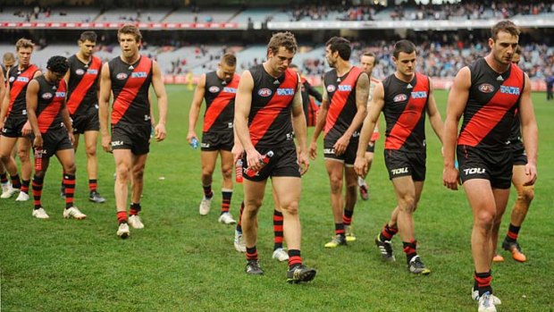 Jobe Watson leads the Essendon team off after the loss to Carlton in round 21 last year.