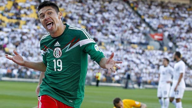 Hat-trick hero ... Mexico's Oribe Peralta celebrates one of his three goals.