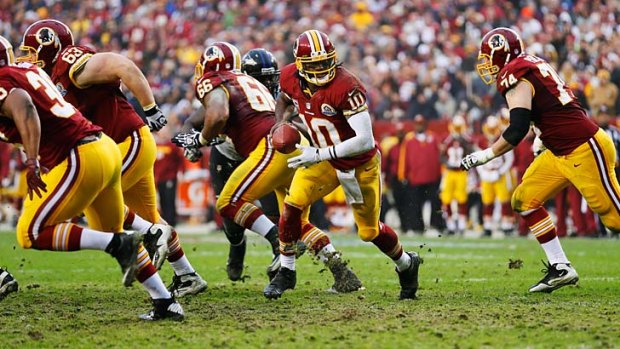 Quarterback Robert Griffin of the Washington Redskins looks to hand off the ball.