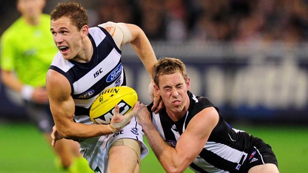Geelong skipper Joel Selwood tries to escape the clutches of his opposite number, Nick Maxwell.