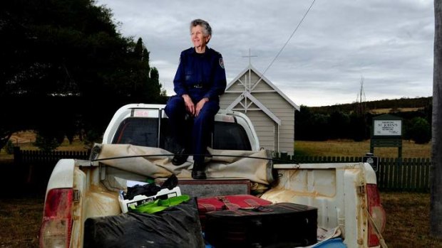 RFS and Ambulance Chaplain Jenni Roberts sits on the back of her ute with the items that she had decided to take with her if her home was destroyed in the fires.
