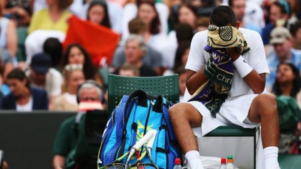 End of the road: Nick Kyrgios sits dejected.