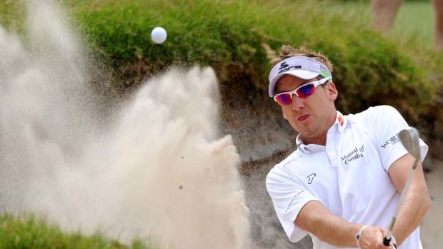 Ill wind: Ian Poulter splashes out of a bunker yesterday at the Australian Masters.