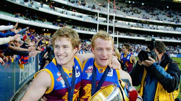 Power with captain Michael Voss after the 2003 grand final.