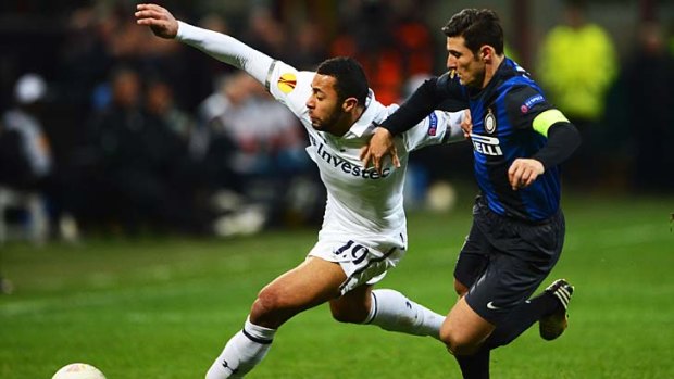 Mousa Dembele of Tottenham Hotspur battles with Javier Zanetti of Inter Milan during their UEFA Europa League Round of 16 second leg match.