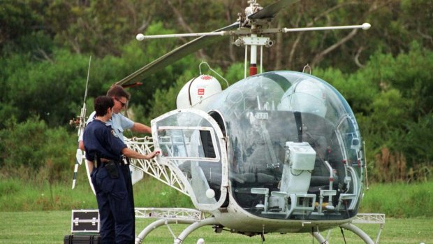 Police examine the helicopter used to break John Killick out of prison.