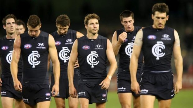 Carlton players leave the field after losing to Port Adelaide on Sunday.
