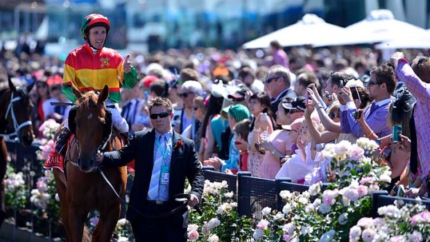 Men of the moment: Damien Oliver and Happy Trails bask in the adulation of the crowd at Flemington after they won the Emirates Stakes.