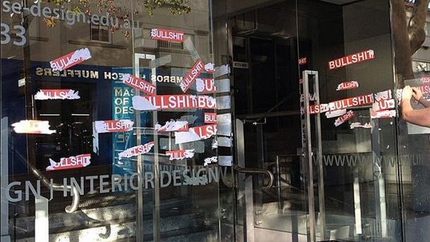 Vandals put stickers over the doors and windows of the Whitehouse Institute of Design in Surry Hills.