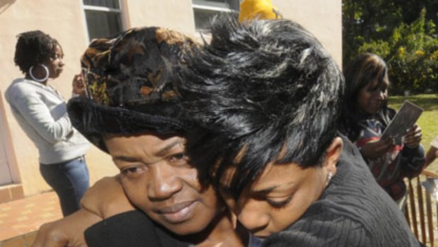 Despair ... Yve Charles consoles her mother, Paulette Michel, after her brother, Evans Charles, was killed.