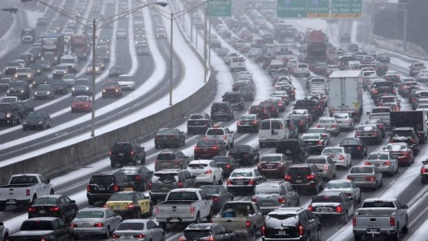 Gridlock ... Traffic crawls along a highway as snow blankets the Atlanta on Tuesday afternoon.