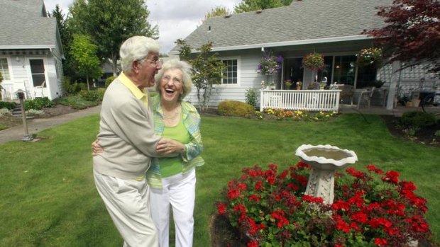 Bruce and Esther Huffman hug as they walk through their back yard in McMinnville, Oregon.