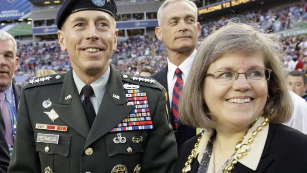 General David Petraeus stands with his wife Holly before the NFL Super Bowl.