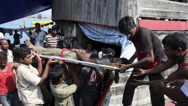 Desperation ... a Sri Lankan  hunger striker is taken to an ambulance after fainting yesterday.