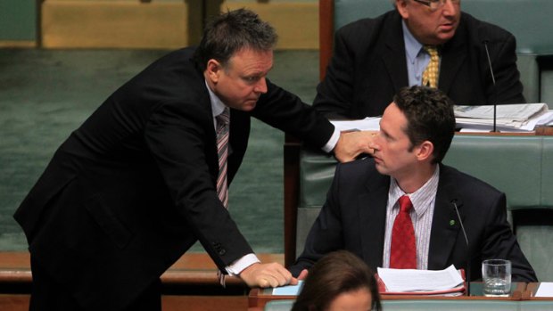 MP for Throsby Stephen Jones is spoken to by the Chief Government Whip Joel Fitzgibbon during question time yesterday.