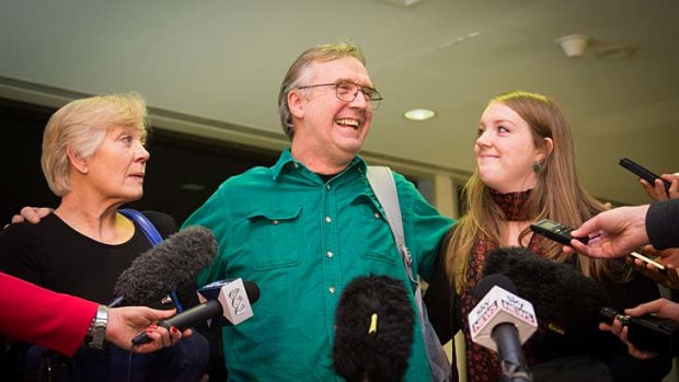Greenpeace activist Colin Russell, with his wife Christine and daughter Madeleine, speaks to the media after arriving back in Hobart.