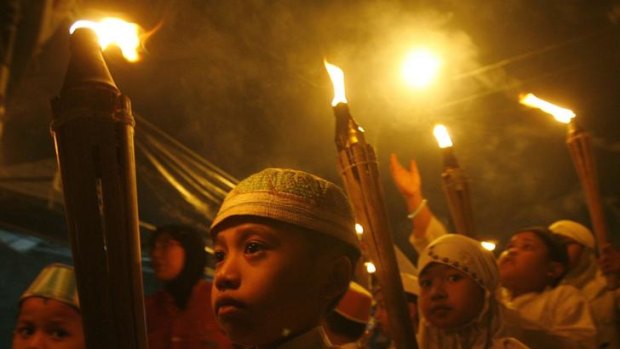 Children holding torches march to mark the end of Ramadan in Jakarta.