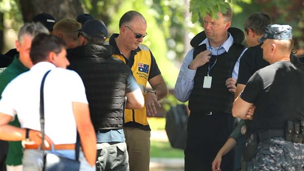 "We have had indications of fighting and we can't take the risk": Alexander Hug, left, with a member of the Australian contingent in yellow vest.