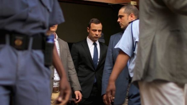 Oscar Pistorius, centre, leaves North Gauteng High Court at the end of the fourth day of his trial on Thursday in Pretoria.  