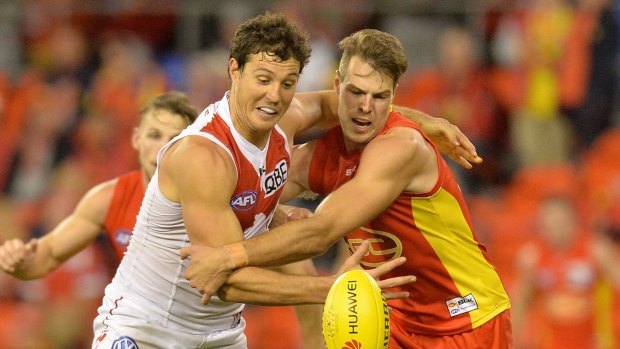 Chasing the sun: Kurt Tippett of the Swans is challenged by the Gold Coast defence. Channel Nine want to televise Sunday afternoon matches.