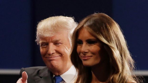 Republican presidential nominee Donald Trump walks off the stage with his wife Melania Trump.
