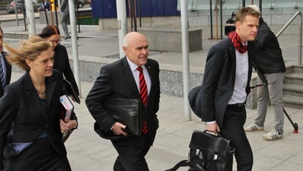 Essendon chairman Paul Little (centre) arrives at the Federal Court for the second directions hearing.