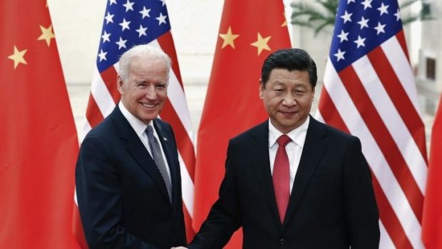 Chinese President Xi Jinping shakes hands with US Vice-President Joe Biden inside the Great Hall of the People in Beijing.