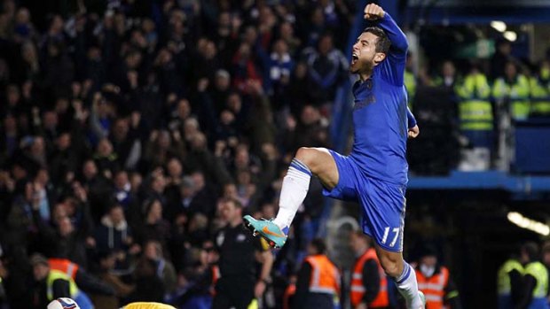 Chelsea's Belgian midfielder Eden Hazard (R) celebrates scoring his late penalty.