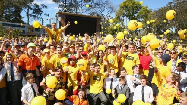 Students pose and release yellow balloons during the Knox Yellow Assembly raising awareness for RUOK? Day at Knox Grammar in Wahroonga