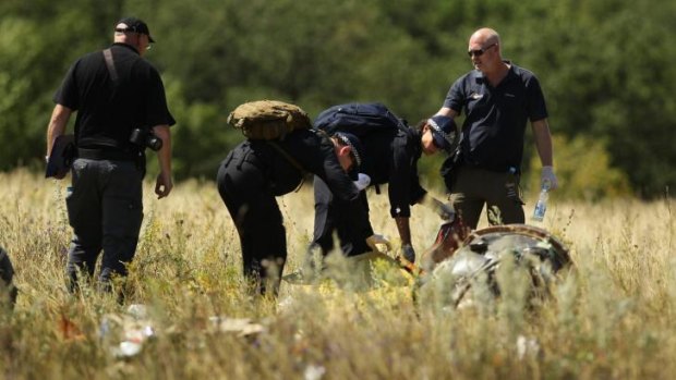 Australian Federal Police searching at the MH17 crash site for human remains.