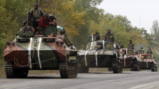Ukrainian servicemen ride on tanks near the town of Debaltseve in Donetsk region.