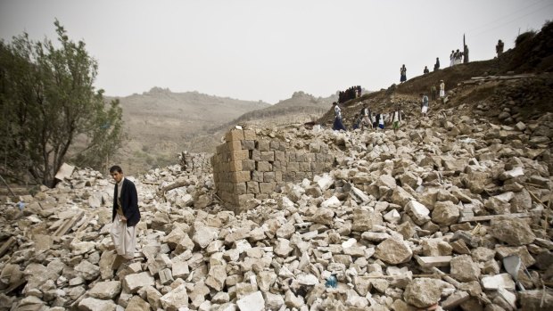 Yemenis search for survivors in the rubble of houses destroyed by  air strikes in a village near the capital Sanaa.