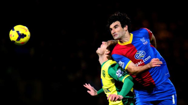 Crystal Palace captain Mile Jedinak wins a header against Norwich City in the English Premier League.