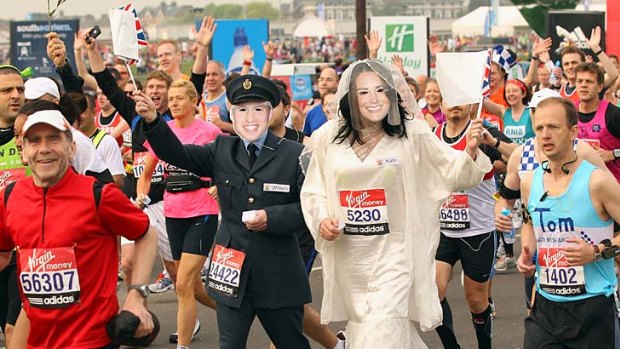 Pumped ... runners dressed as Prince William and Kate Middleton at the start of the London Marathon on Sunday.