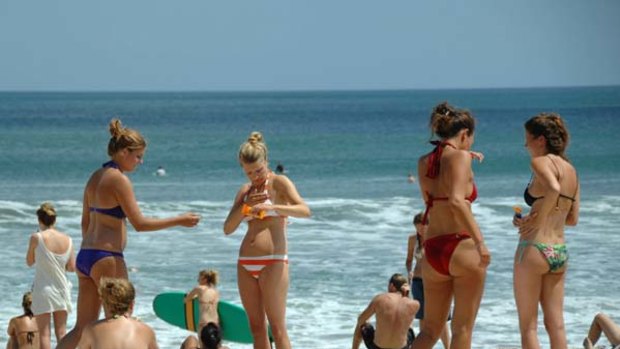 In recovery ... tourists are returning to Bali and its famed Kuta beach.