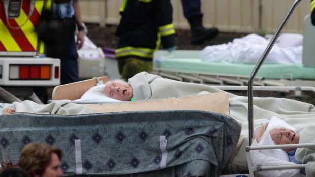 Too frail to flee ... elderly residents wait to be evacuated from the Quakers Hill Nursing Home. Witnesses have told how some firefighters used a garden hose to spray trapped residents.
