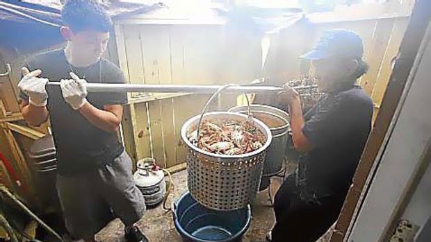 Cuong Nguyen (left) and his father, Son Le, at work in their seafood restaurant.