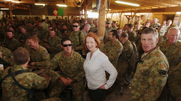Taste of home &#8230; Julia Gillard shares a barbecue with Australian troops at Tarin Kowt as she affirms the government's commitment to Afghanistan.
