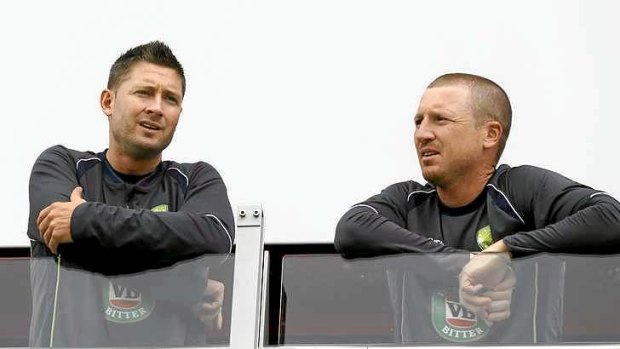 What might have been: Australia's captain Michael Clarke and Brad Haddin survey a gloomy Old Trafford.