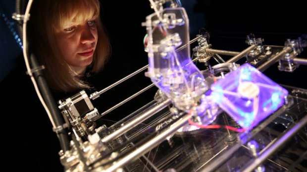 Installation designer Susana Soares looks at a 3D printer at the 'Insects au Gratin' exhibition at the Wellcome Collection in London.