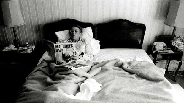 Malcolm Fraser reads the paper in his Hotel Windsor suite after his 1980 re-election win.