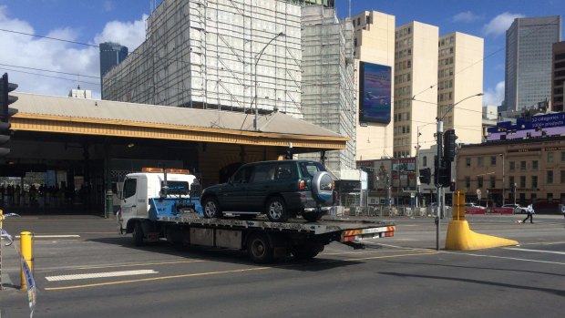 The RAV4 vehicle being towed away from the scene.