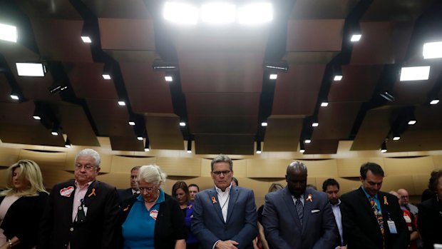 At a vigil for victims of the mass shooting, attendees bow their heads during a prayer delivered by Karen Pence, wife of Vice-President Mike Pence on Saturday.