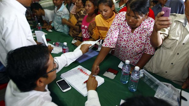 National Rescue Party supporters give their thumbprints as they complain that their names were not in the voting lists in July 28 election.