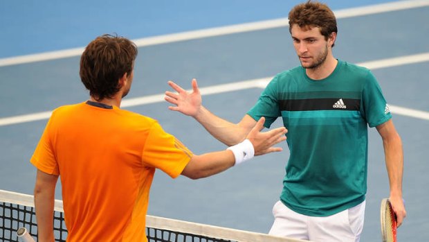 Frenchman Gilles Simon congratulates Marcos Baghdatis in his win on day six of the Brisbane International at Pat Rafter Arena.