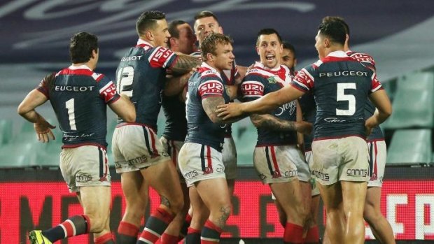 Another notch: Roosters players celebrate a try against the Storm on Saturday night.