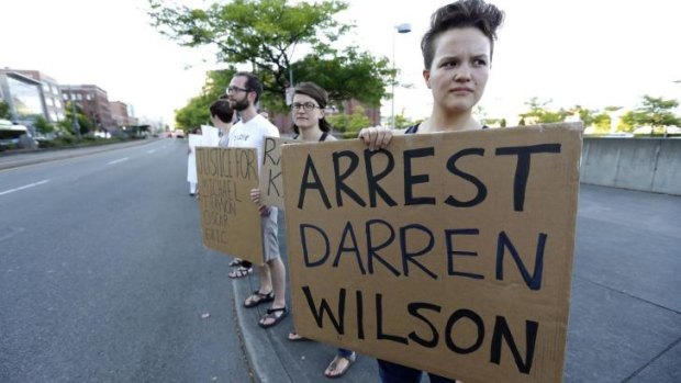Protesters in Washington state call for the arrest of police officer Darren Wilson.
