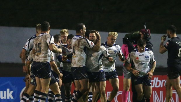 History: Euan Aitken celebrates his try as the Bravehearts became the first minnows to claim a Four Nations point.